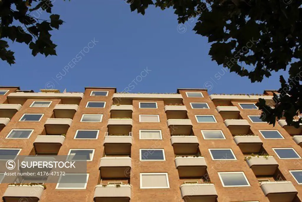 Residential building behind leaves, Copenhagen, Denmark.