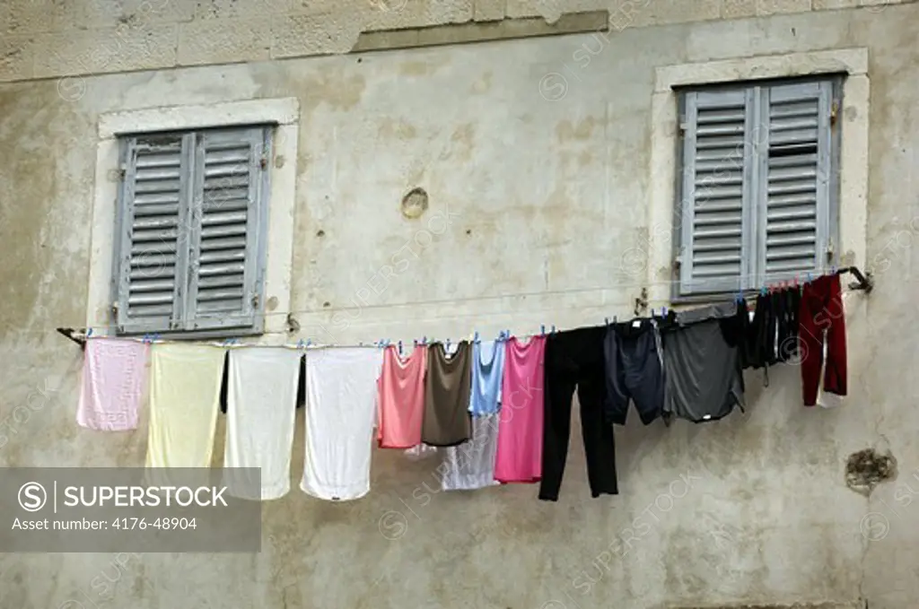 Low angle view of clothes hanging at the window of a laundry, Split, Dalmatia, Croatia