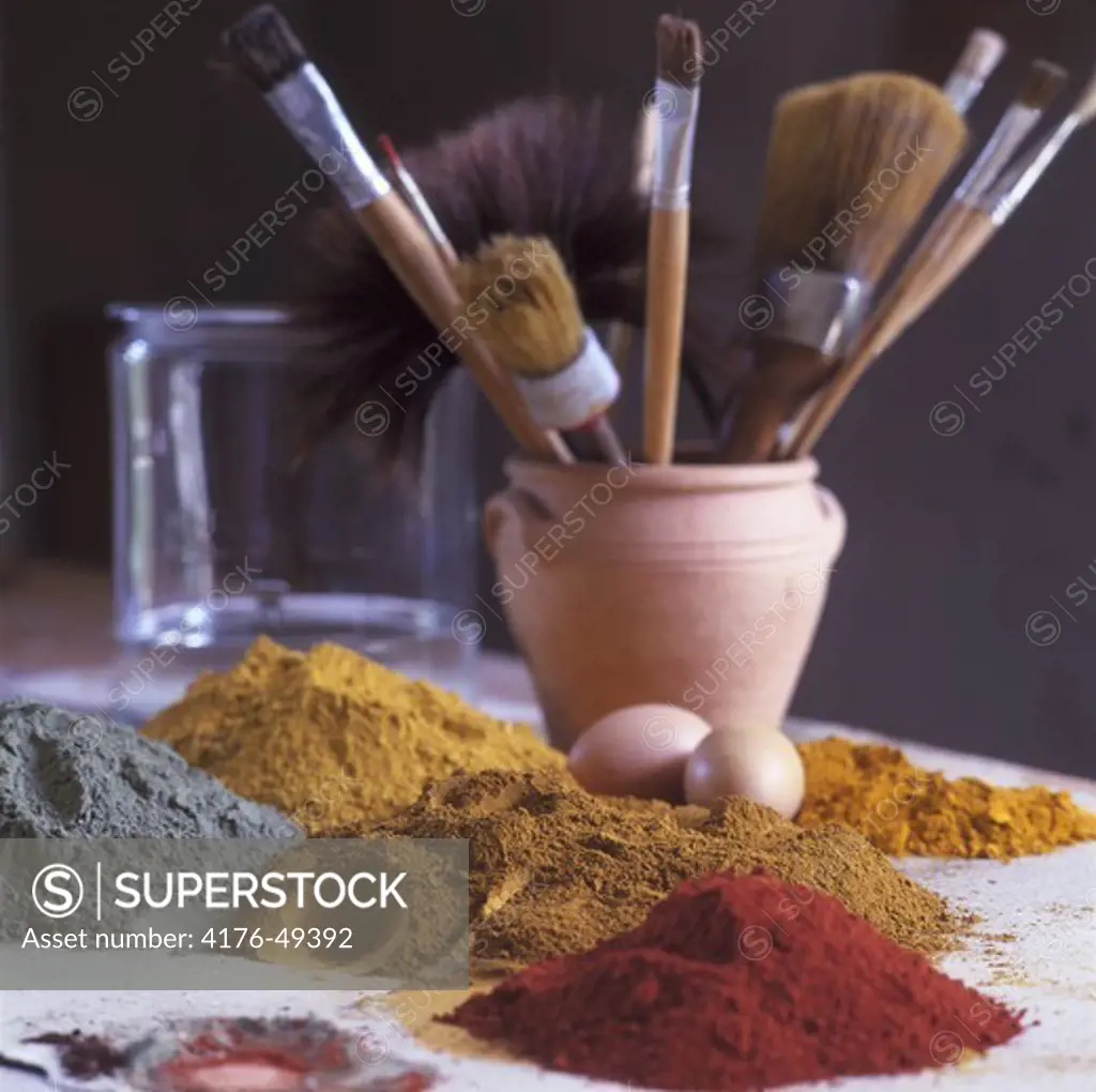 Mixed spices with eggs and pot of brushes