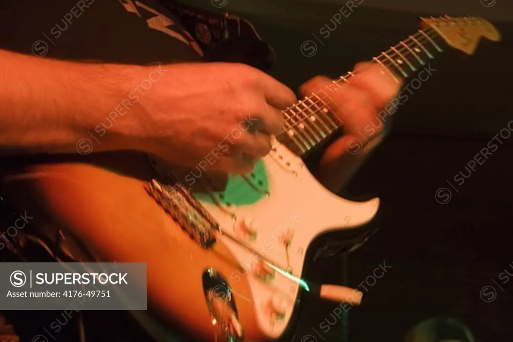 Musician playing on his Stratocaster