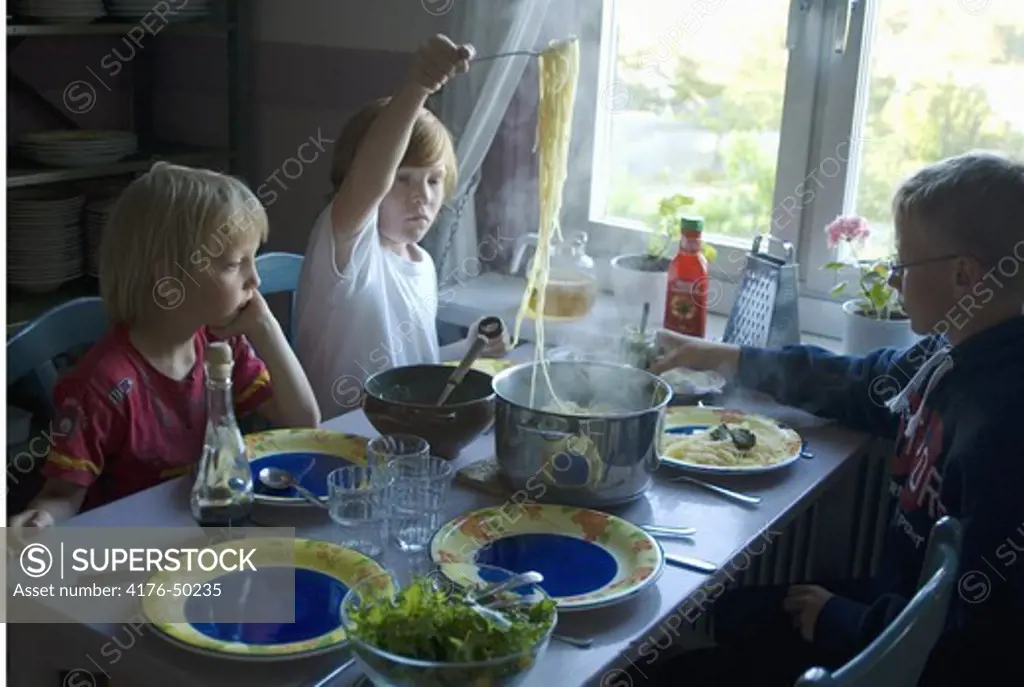 Boys eating spagetti, Stockholm, Sweden