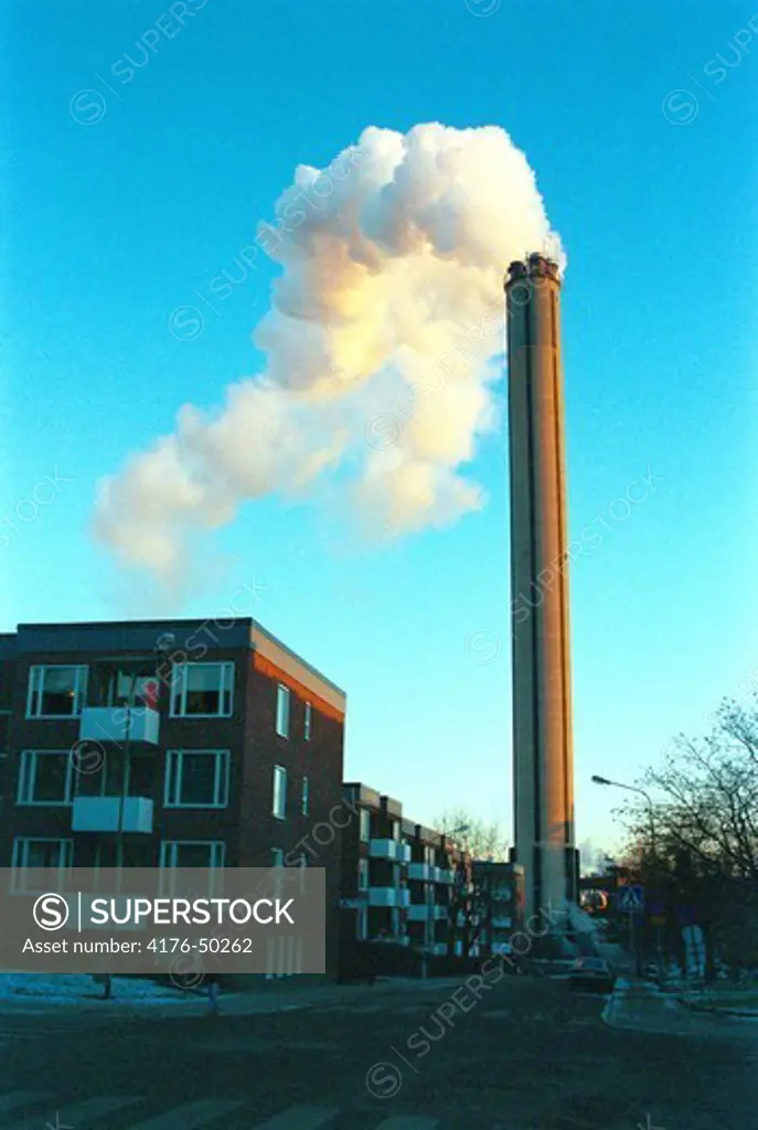 Livinghouse close to a coal powerplant with a smokestack. Stockholm. Sweden.