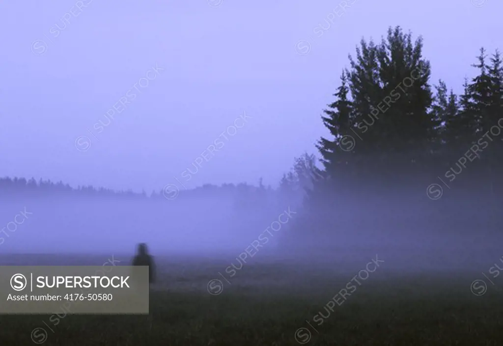 Woman walking away in fog, Kungsängen, Upplands-Bro