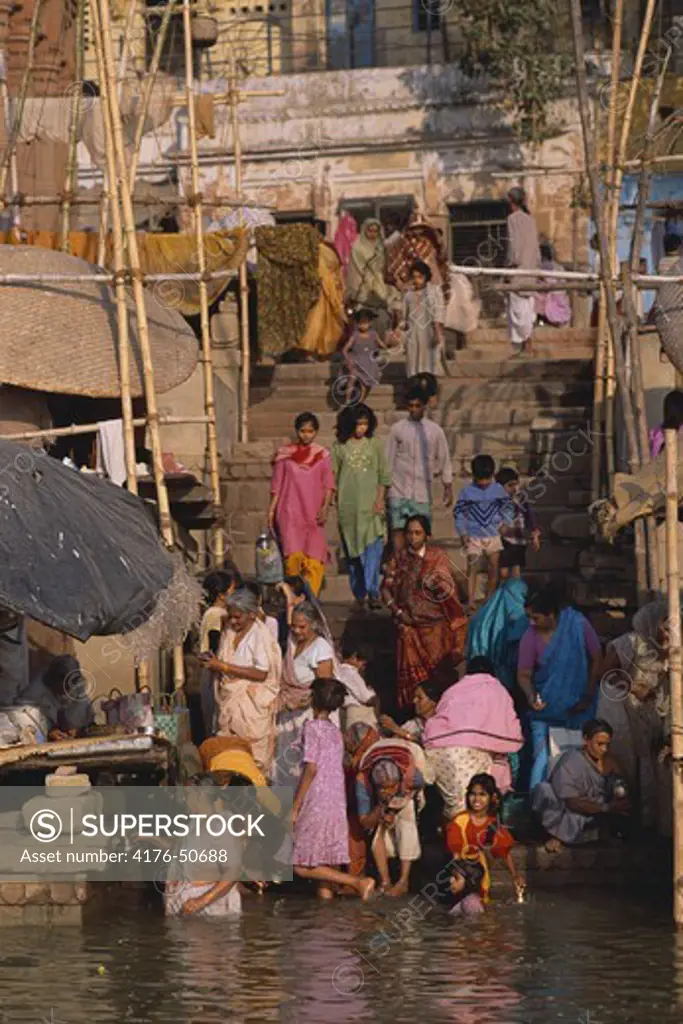 Hindu women at the ghats, praying in the holy water