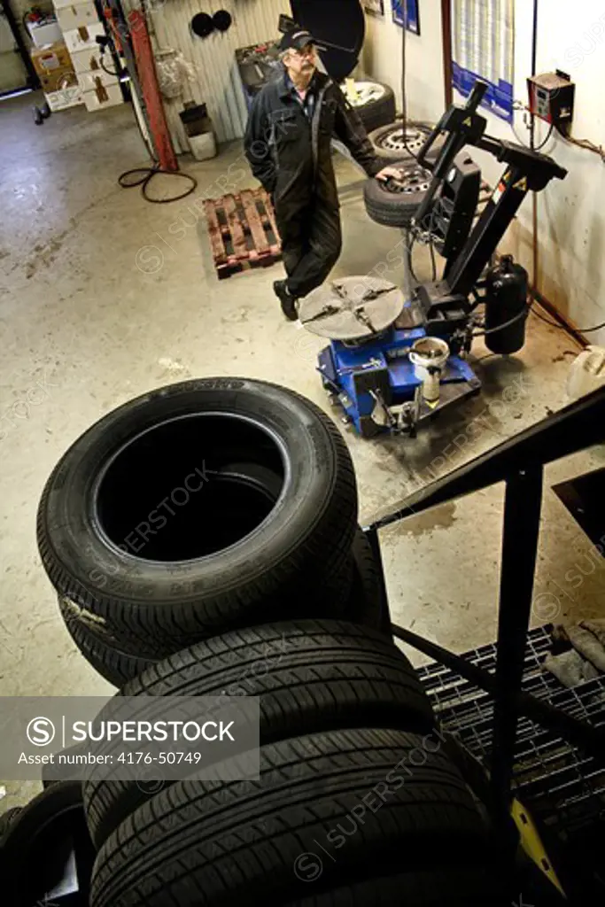 Vulcanizing shop with rubber tyred wheels and a worker, Sweden