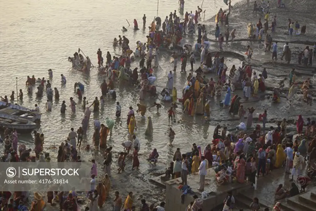 Hindus bathing at the ghats in the holy River Ganges at sunrise, Varanasi, (Benares), India