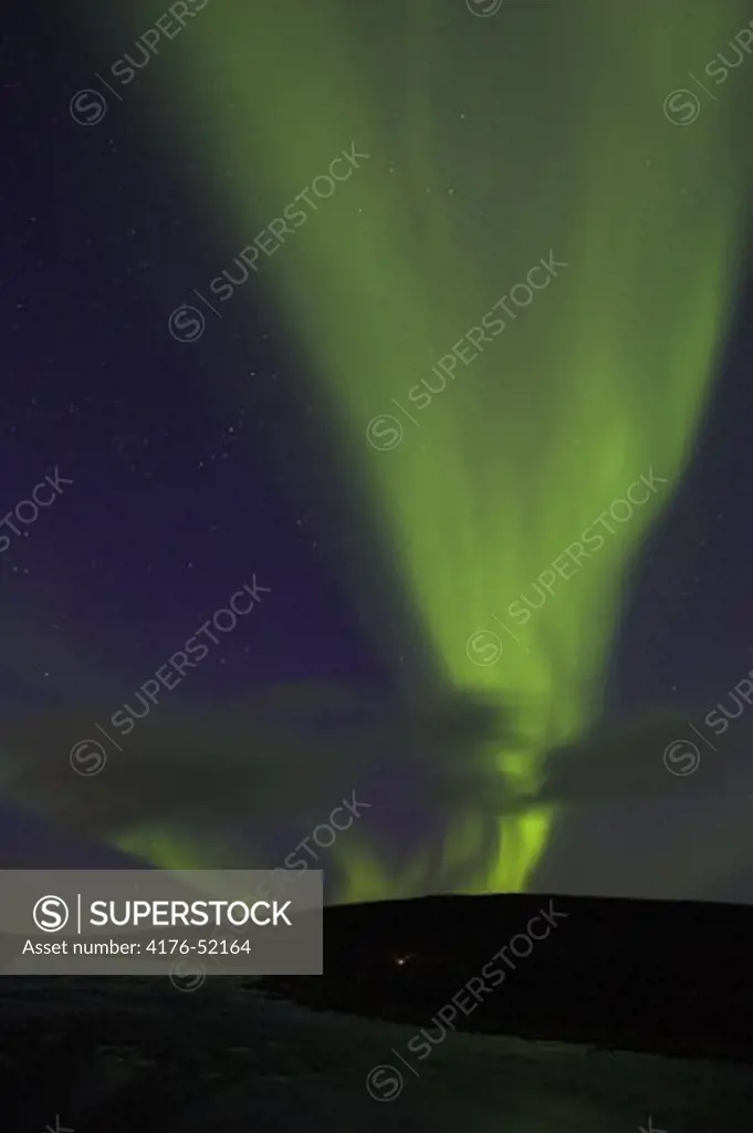 Northern lights over camp by Lainio River on the Swedish Arctic tundra, Lapland