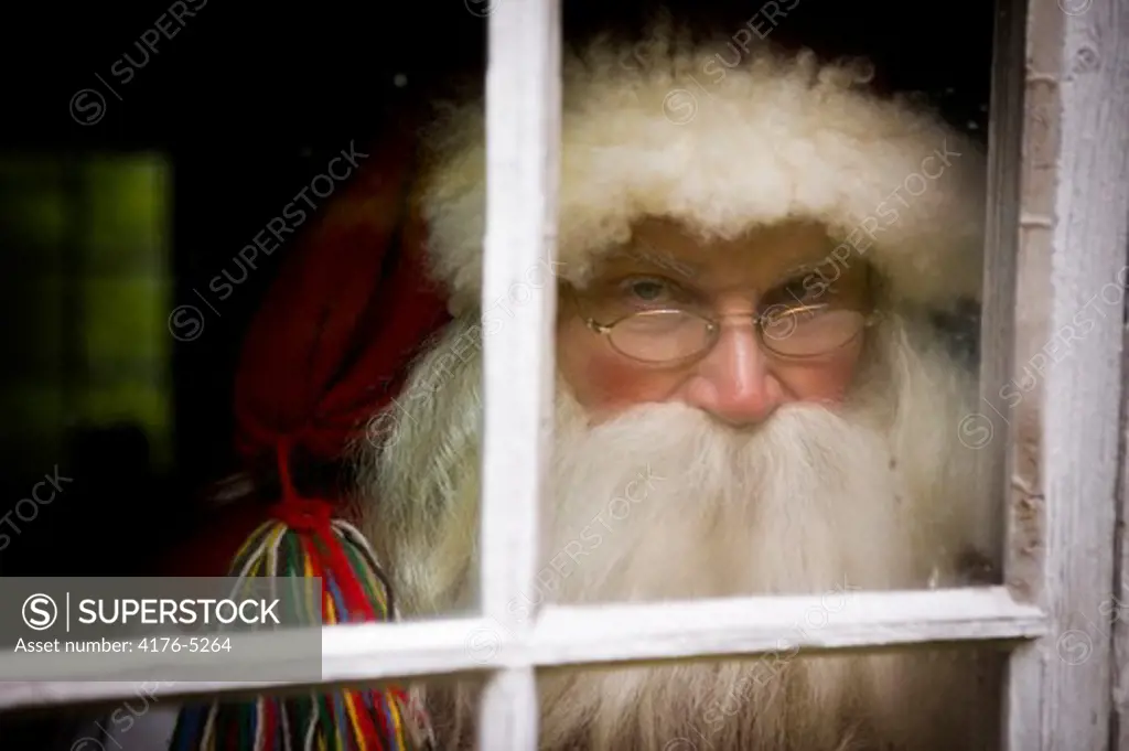 Santa Claus looking through a window