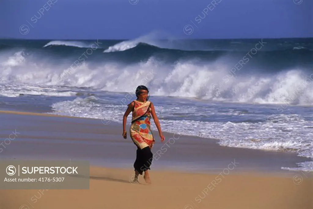 Polynesian woman on windy beach in Hawaii