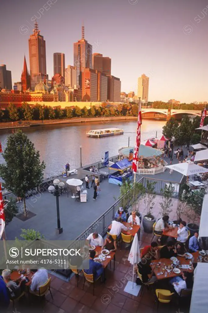 Dining at Southgate Complex on the Yarra River under Melbourne Skyline near sunset