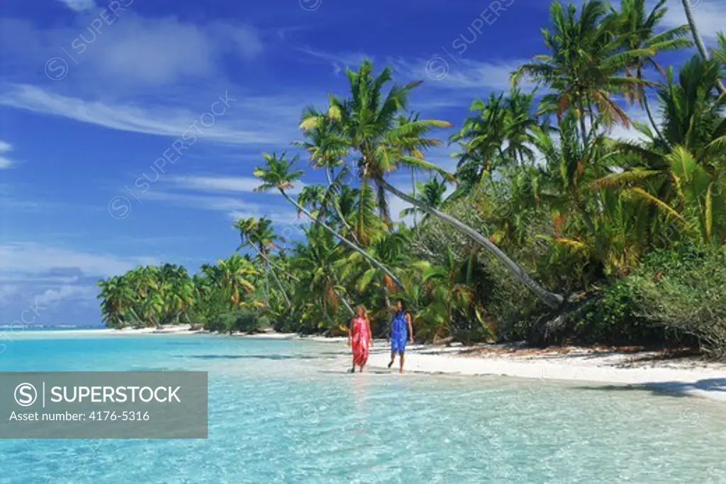 Two women walking on One Foot Island off Aitutaki in Cook Islands