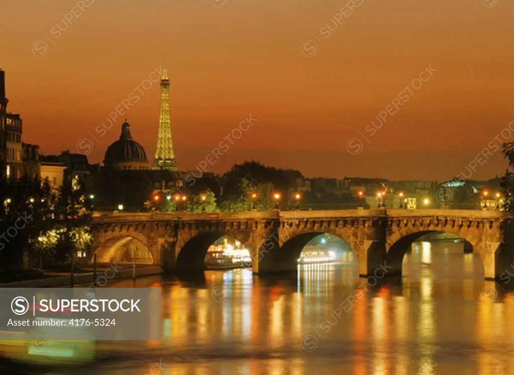 Pont Neuf across River Seine with Eiffel Tower at night
