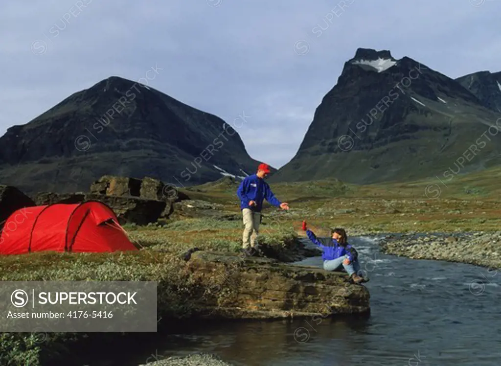 Couple camping and hiking in Swedens Arctic wilderness near Mount Kebnekaise