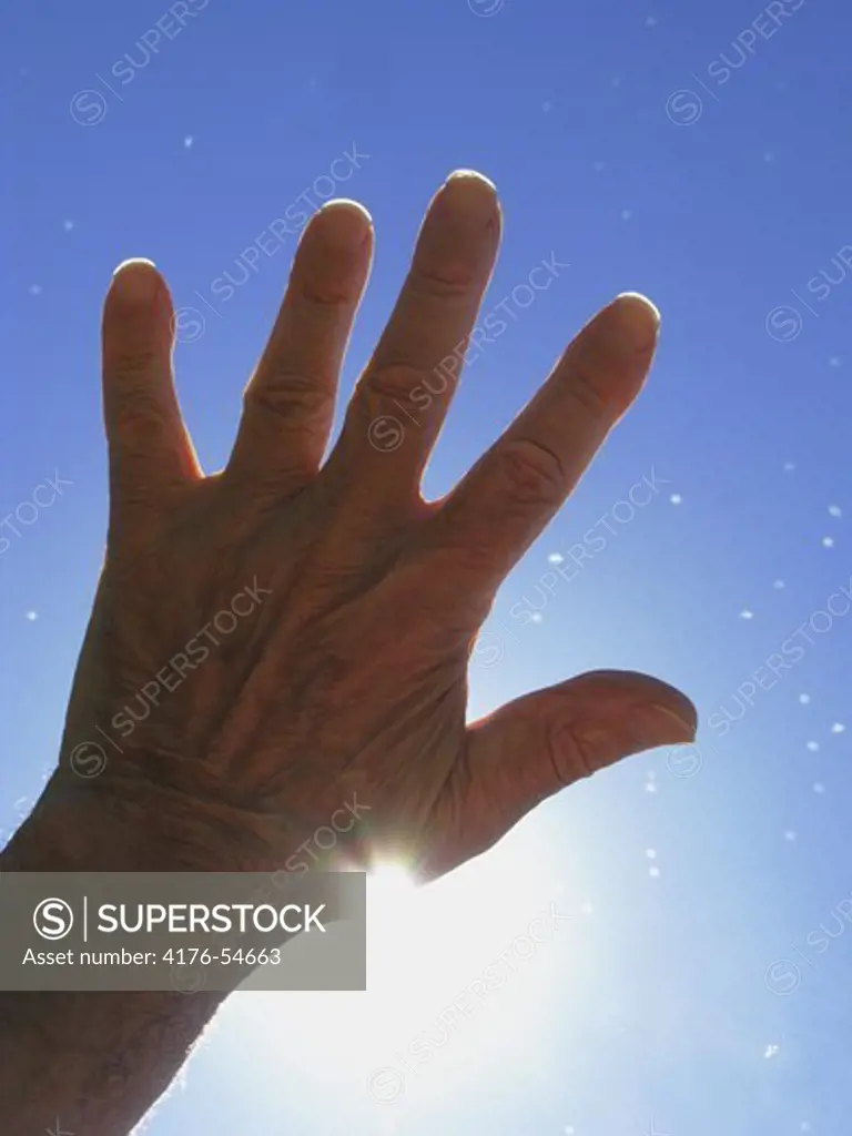 Mans hand towards the sky