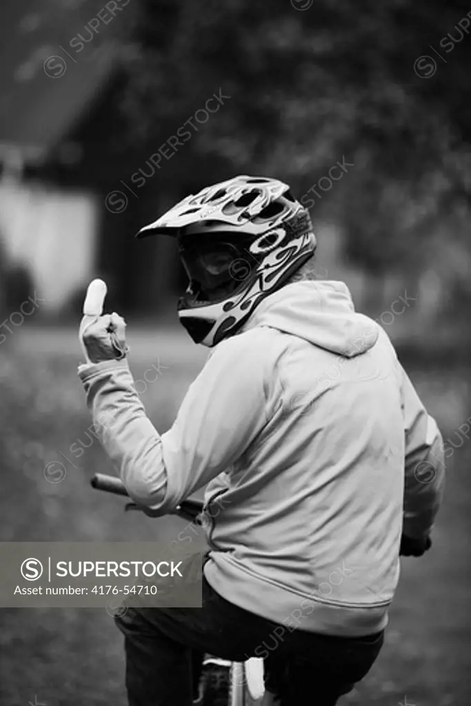 Cyclist on mountainbike showing his middle finger
