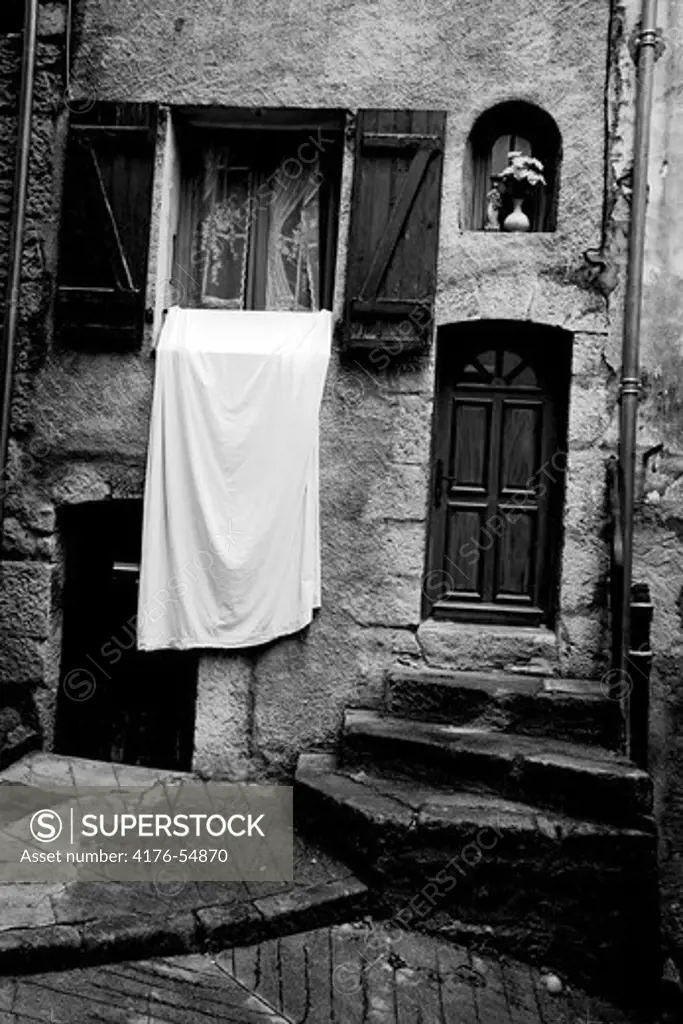 Sheet drying by a window, south France.