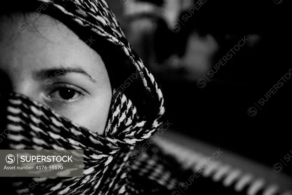 A women covering her face and hair.