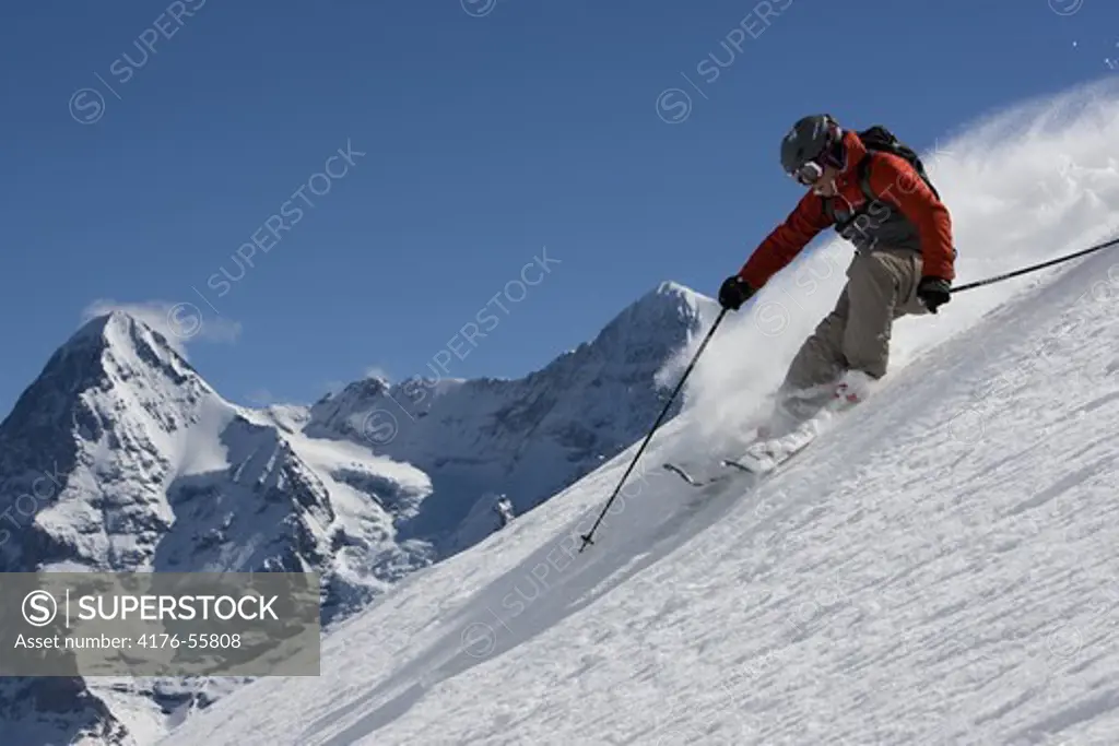 Skier with peaks in the background in Murren, Switzerland
