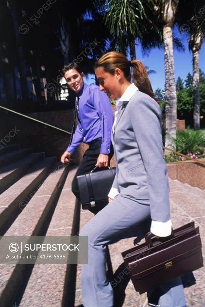 Businessman and women walking up stairs in downtown Los Angeles