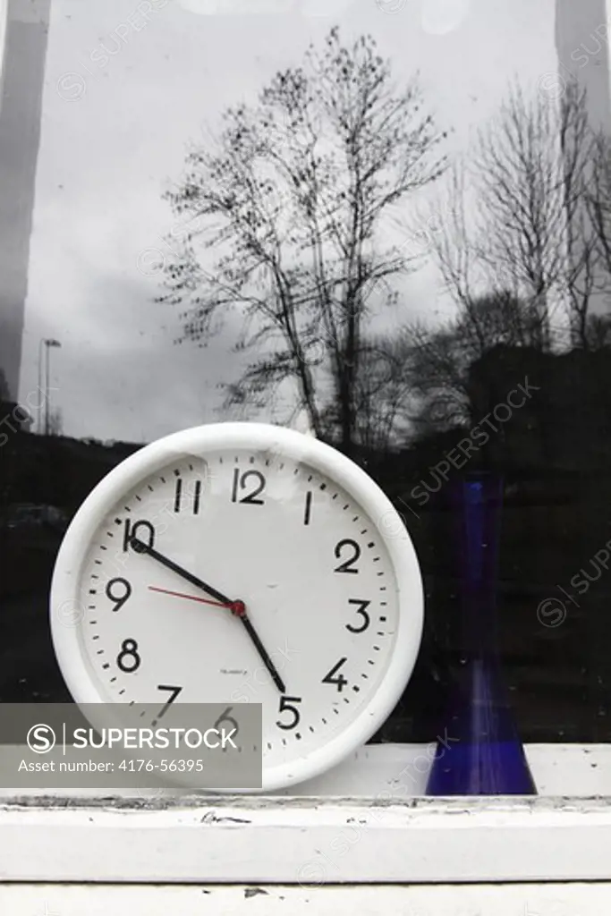 Round clock in a window, Sweden.