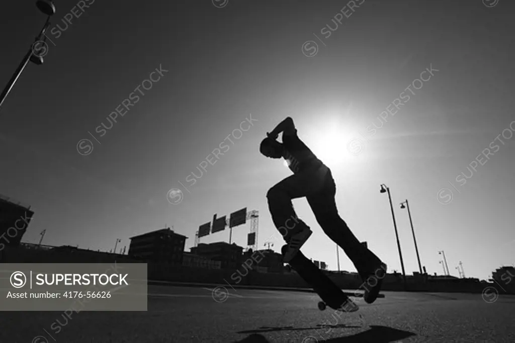Young man doing a 360 kick-flip on a skateboard, Gothenburg (Göteborg), Sweden.