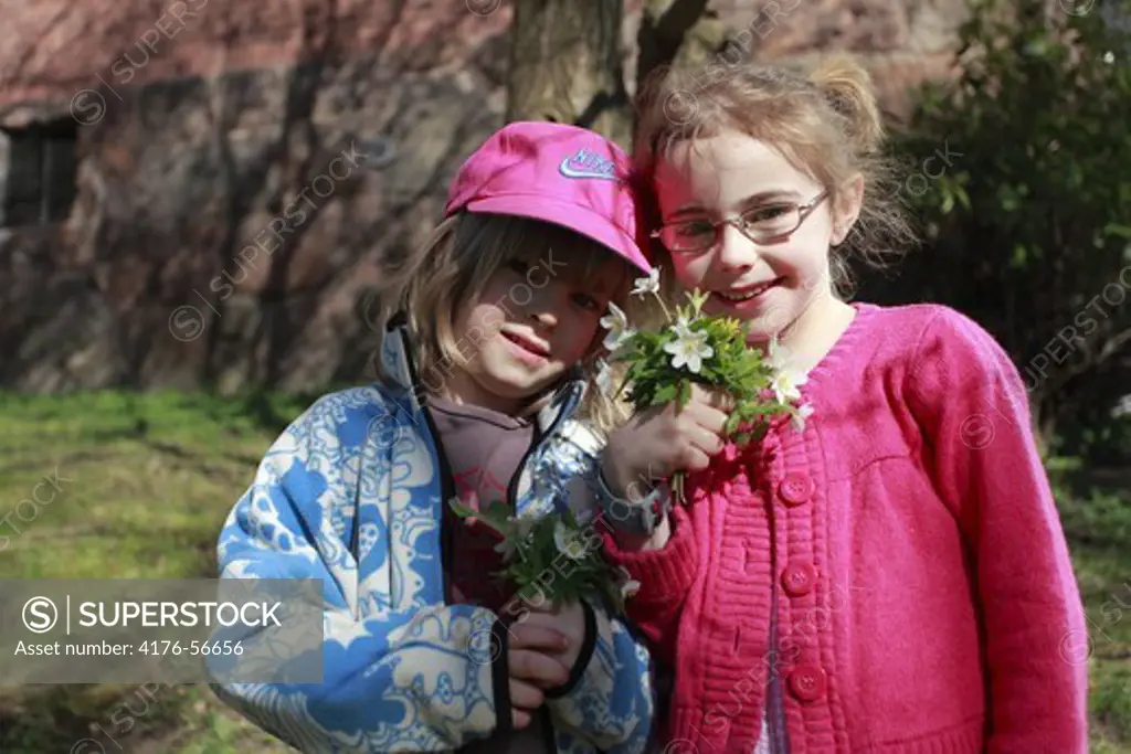 Two children with flowers, Sweden.
