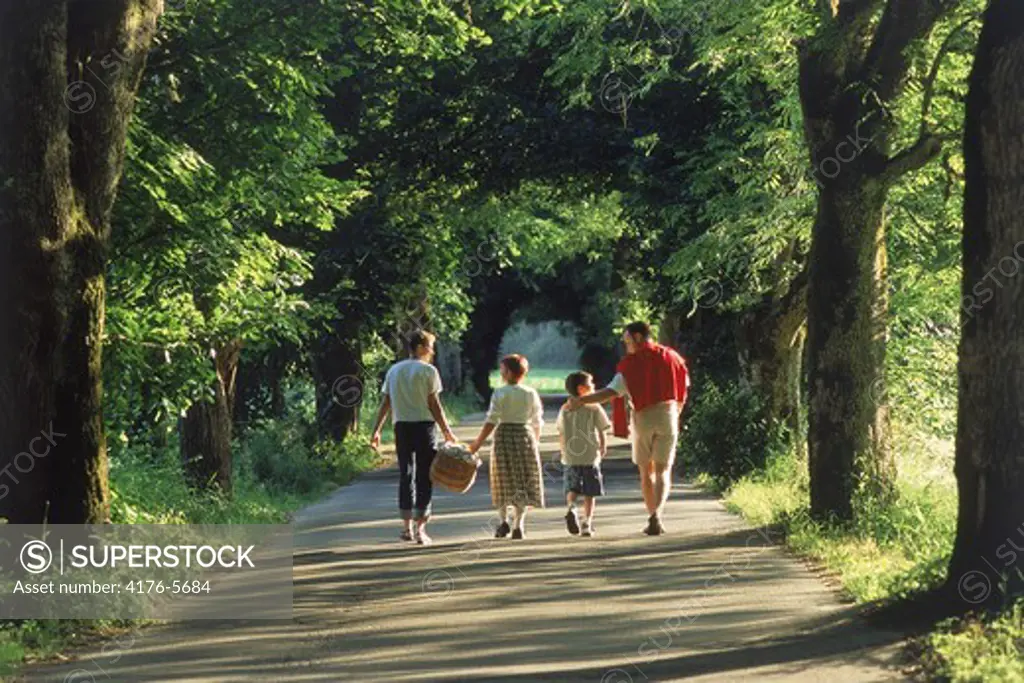 Family of four strolling down country road near Munich Germany
