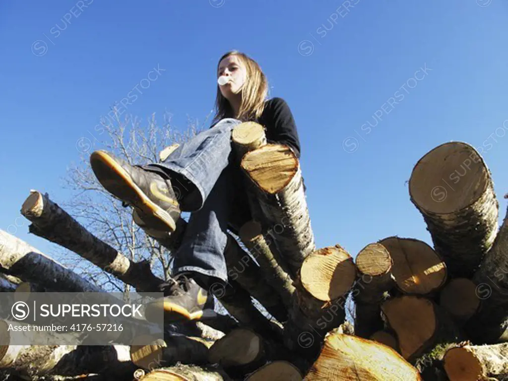 A girl sitting on logs, Sweden