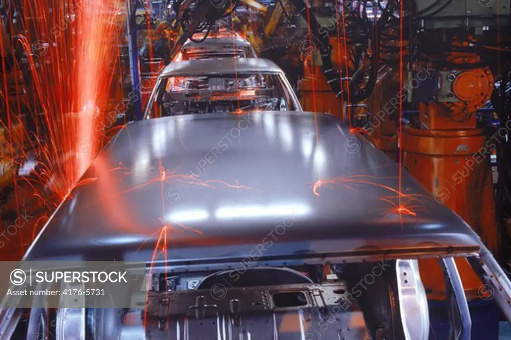 Sparks flying from spot welding robotics at Volvo Torslanda Plant in Sweden