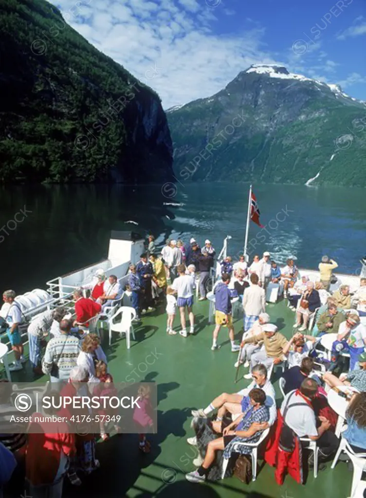 Passengers on deck of car ferry during scenic tour of Geirangerfjord in Norway