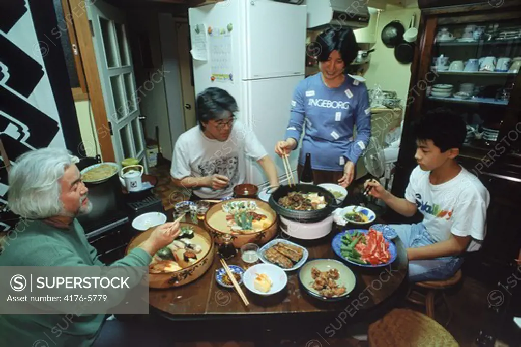 Japanese family eating meal together in typical apartment