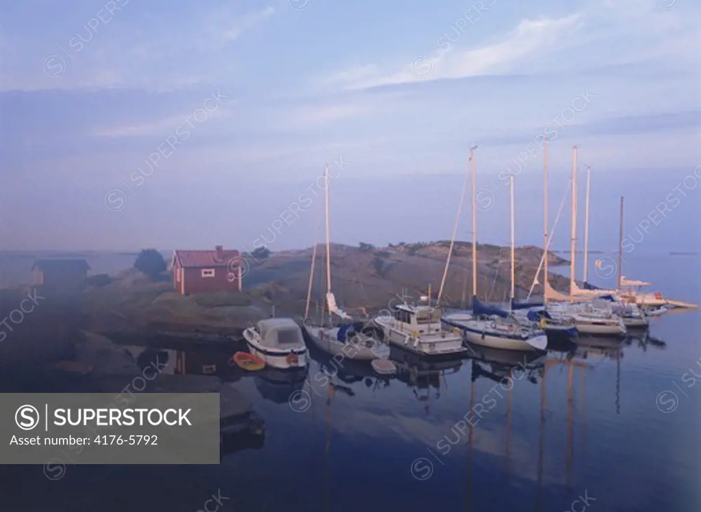 Sailboats anchored at dawn in Stora Nassa island group of Stockholm Archipelago