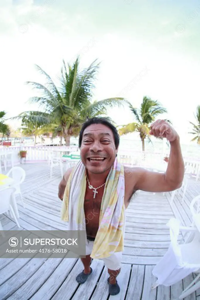 Man showing his biceps, San Pedro, Ambergrise Caye, Belize.