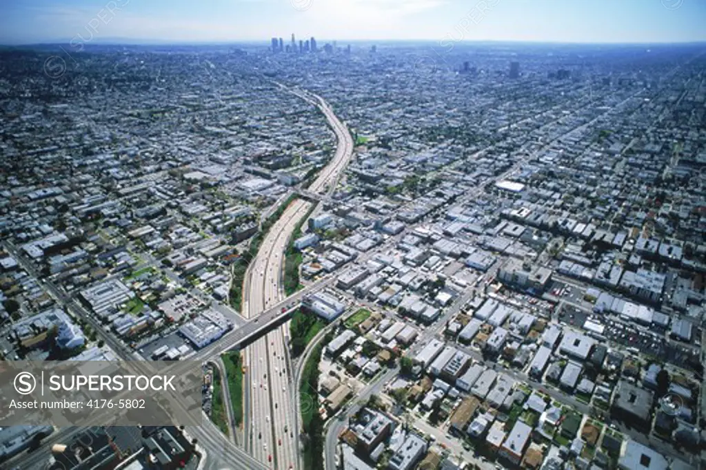 Aerial view of freeway cutting through Los Angeles urban sprawl