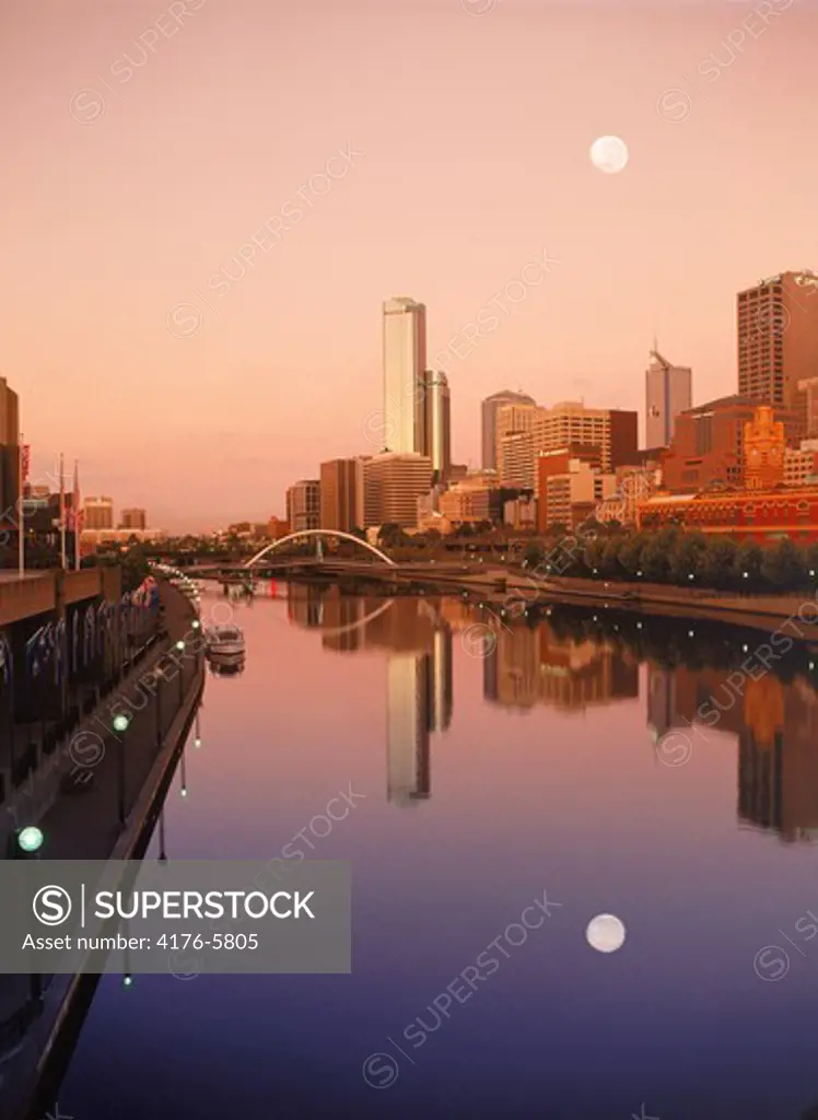 Central Business District and full moon reflecting off Yarra River in Melbourne