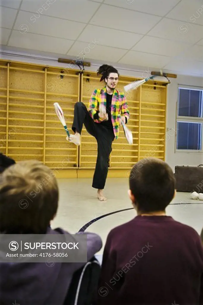 Performance of juggler  before a school class.