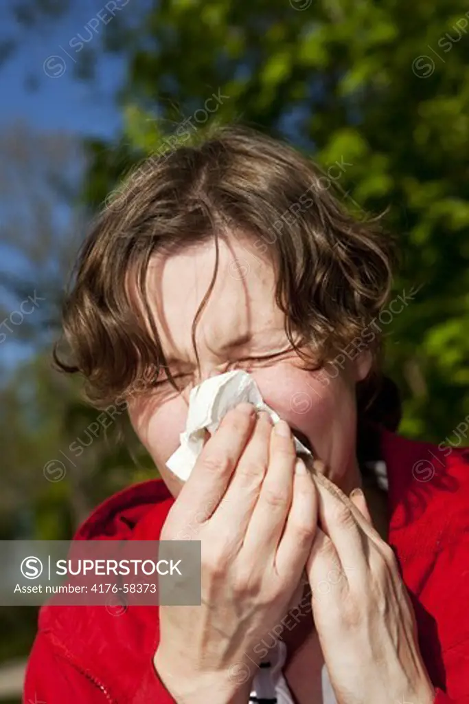 Women blowing her nose from a allergic reaction.Nashulta,Sweden