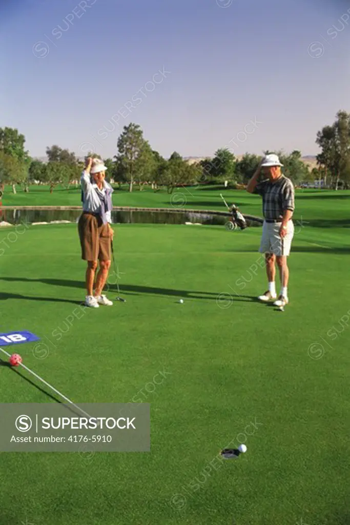 Couple in their 70s playing golf in Palm Springs California