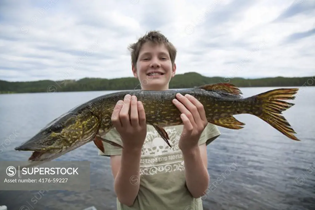 Proud of his fish, Jamtland, Sweden