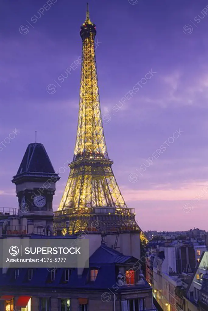 Top floor apartment with clock tower and Eiffel Tower at dusk