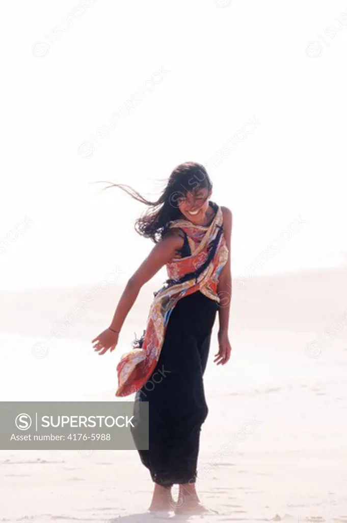 Polynesian woman on windy Hawaiian shore
