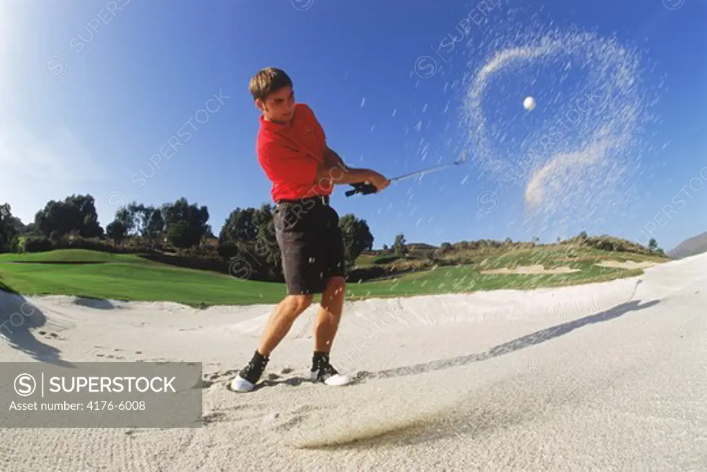 Halo of sand encircliing golf ball hit from bunker on Costa Del Sol course in Spain