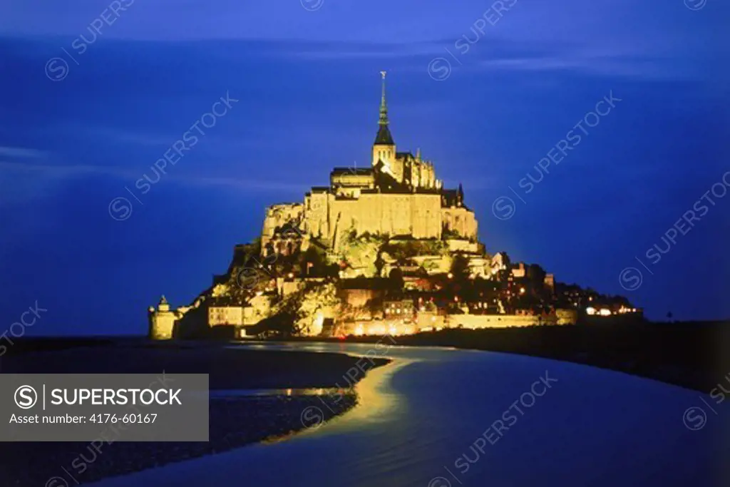 Le Mont-Saint-Michel at the mouth of the Couesnon River near Avranches in Normandy, France at night