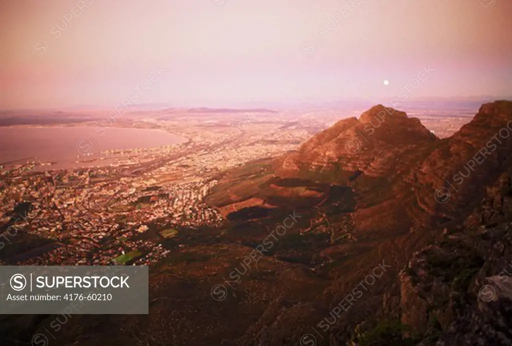 Moon over Cape Town and Table Bay at twilight from Table Mountain, South Africa