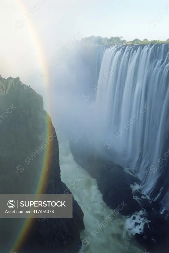 Rainbow across spray rising off Zambezi River at Victoria Falls