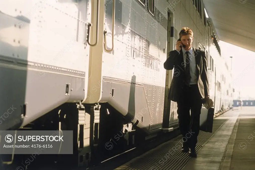 Businessman at Los Angeles Central Station with cell phone and briefcase