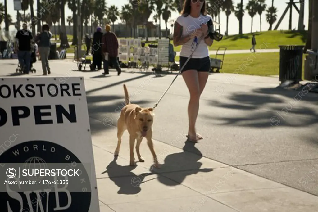 Woman with dog, Venice Beach, Los Angeles, California, USA