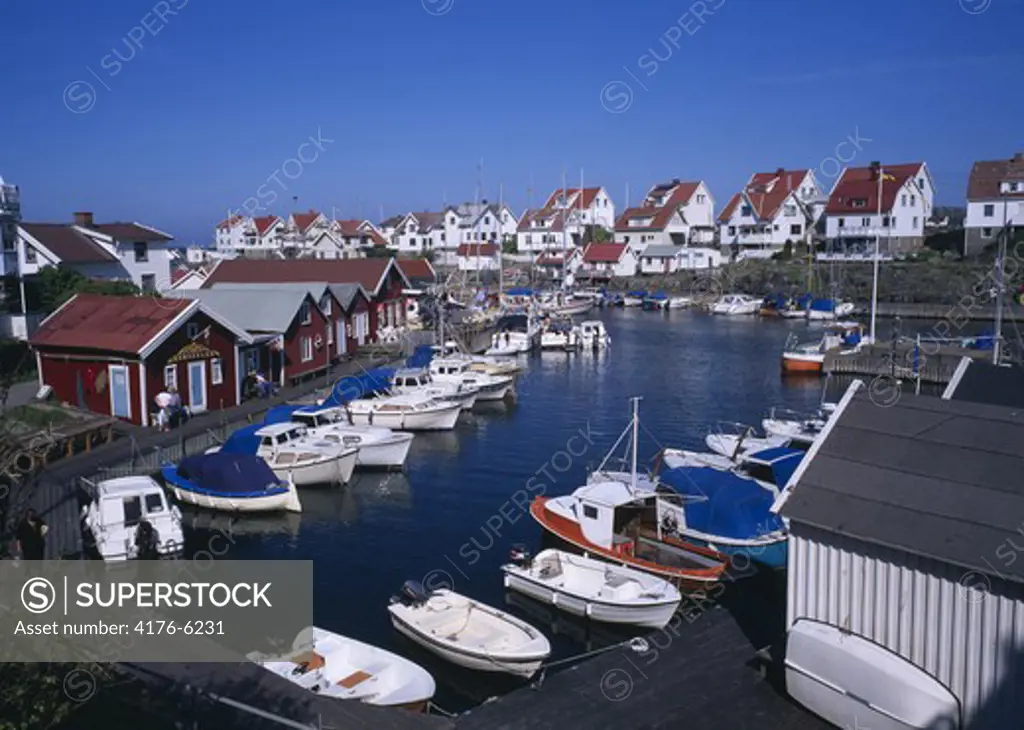 High angle view of houses and boats moored on harbour