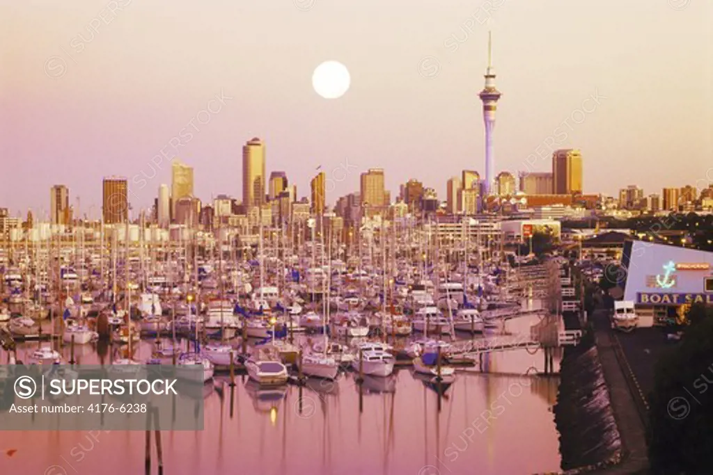 Moon over Waitemata Harbour (Westhaven Harbour) with Skytower in Auckland skyline