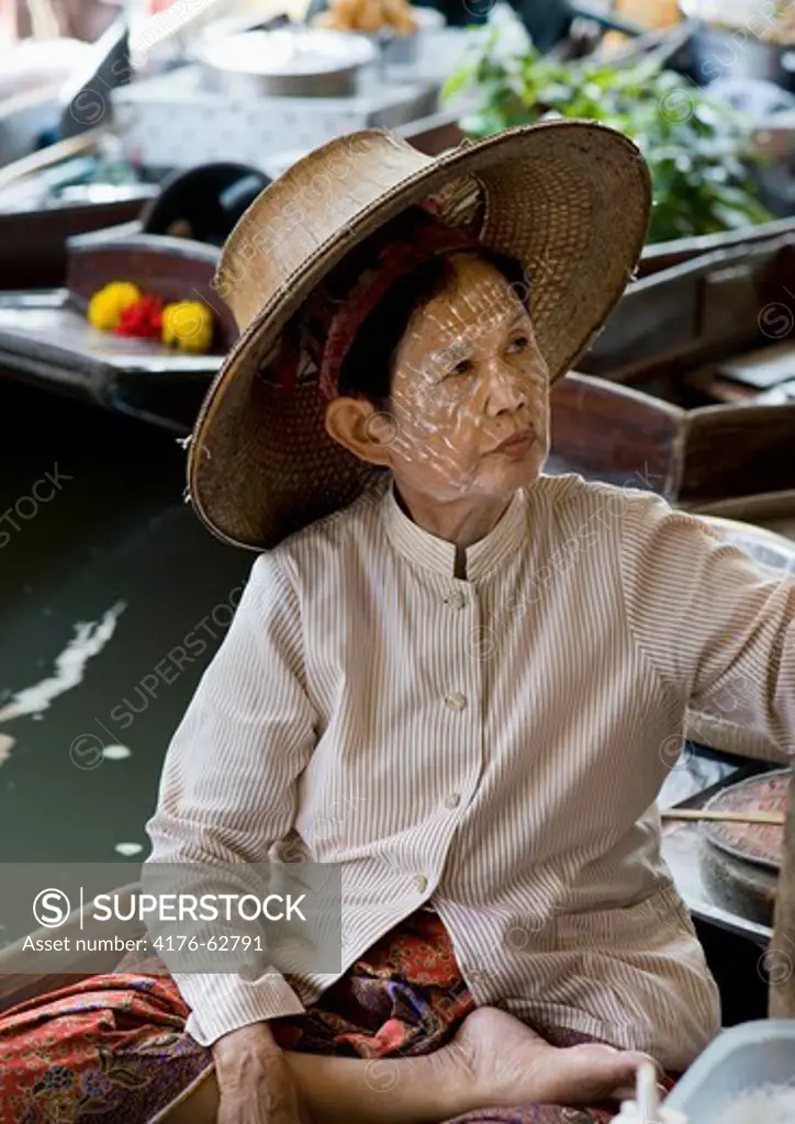 A woman, in the floating market in Damnoen Saduak,